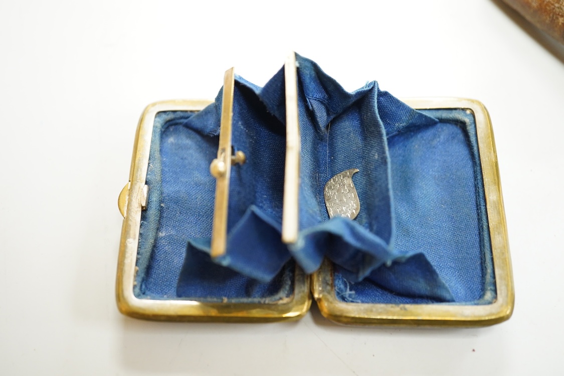 A George V engine turned silver mounted rectangular cigarette box, Birmingham, 1923, 17.7cm, a sterling mounted pepper grinder, four weighted sterling condiments and a small plated tray.
